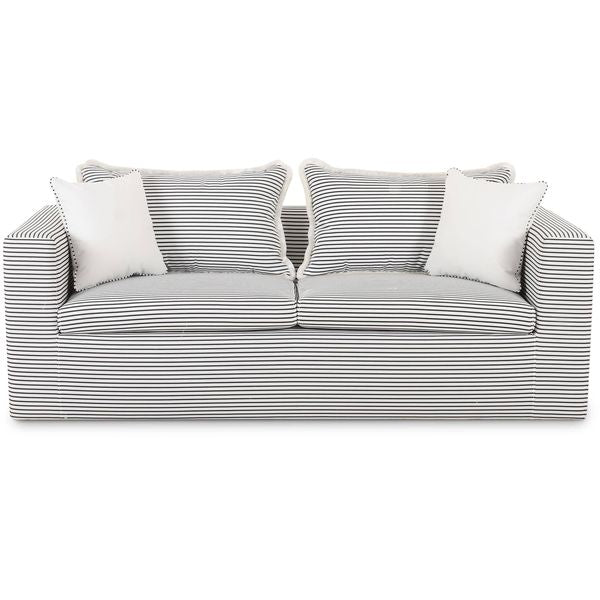 Sofa tapicerowana o miekkim zarysie z lyagodnym konturem w odcieniu bieli do salonu